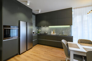 Modern trendy luxury dark gray kitchen with dining table